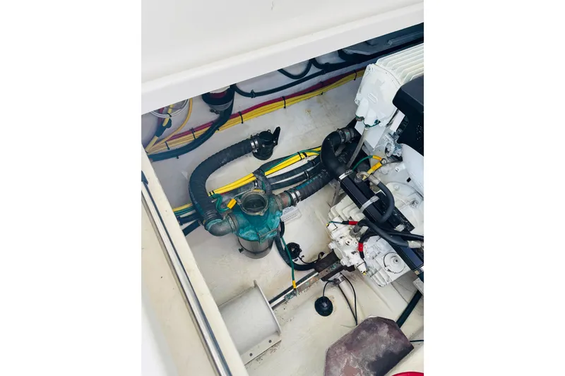 Slide: The Image of Engine compartment of a 2007 Back Cove 29 boat, showing hoses and wiring. - 22