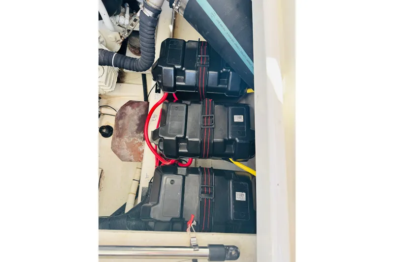 Slide: The Image of Battery compartment of a 2007 Back Cove 29 boat, featuring secured black battery boxes. - 23