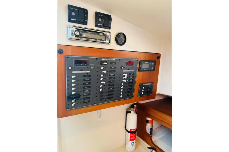 Slide: The Image of Control panel of a 2007 Back Cove 29 boat with switches and fire extinguisher. - 26