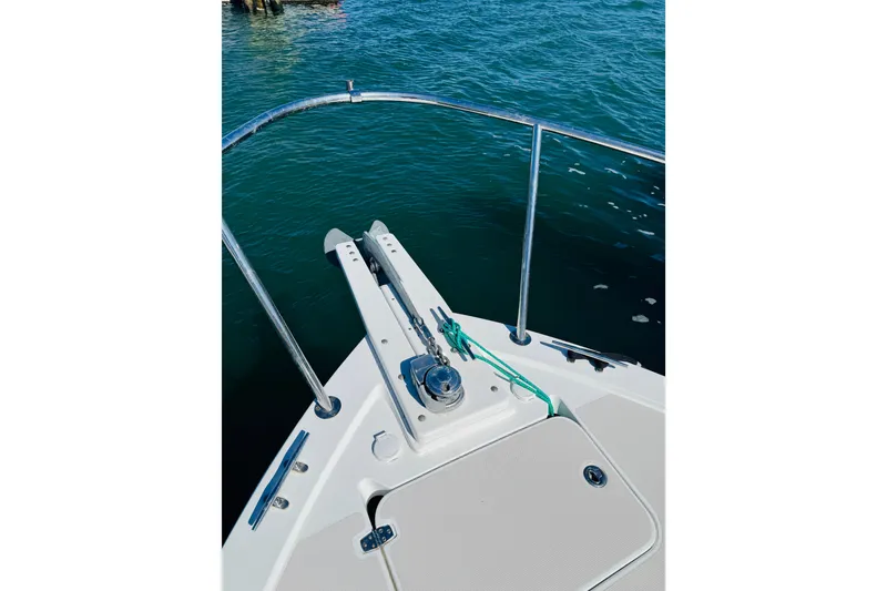 Slide: The Image of Bow of 2007 Back Cove 29 boat with anchor and railing on calm water. - 32