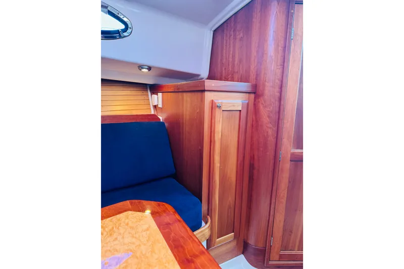 Slide: The Image of 2007 Back Cove 29 interior with wooden cabinetry and blue seating. - 5