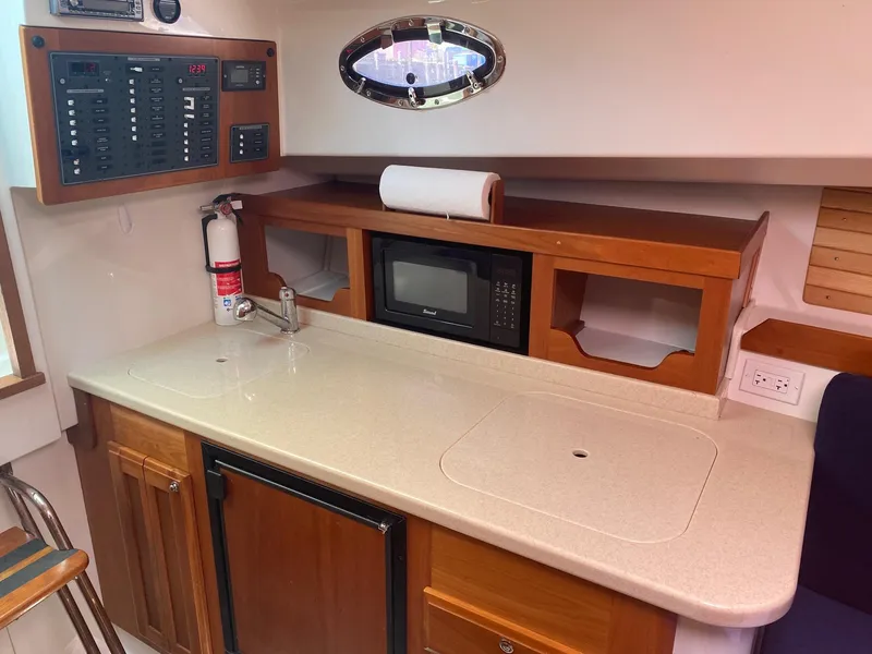 Slide: The Image of 2007 Back Cove 29 yacht interior with kitchenette, microwave, and control panel. - 6