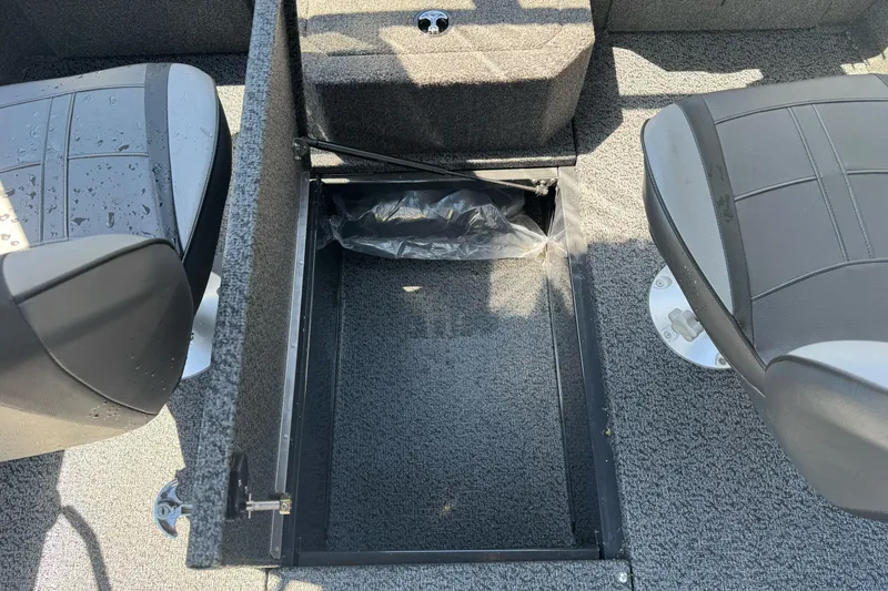 Slide: The Image of 2026 Lund 1775 Crossover XS boat interior with storage compartment and seating. - 16