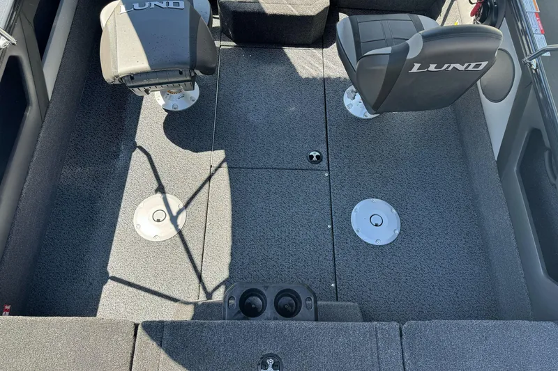 Slide: The Image of 2026 Lund 1775 Crossover XS boat interior with two seats and carpeted flooring. - 7