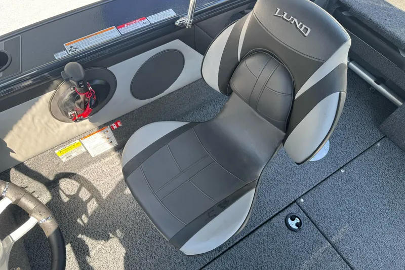 Slide: The Image of 2026 Lund 1775 Crossover XS boat interior with ergonomic seating and control panel. - 11