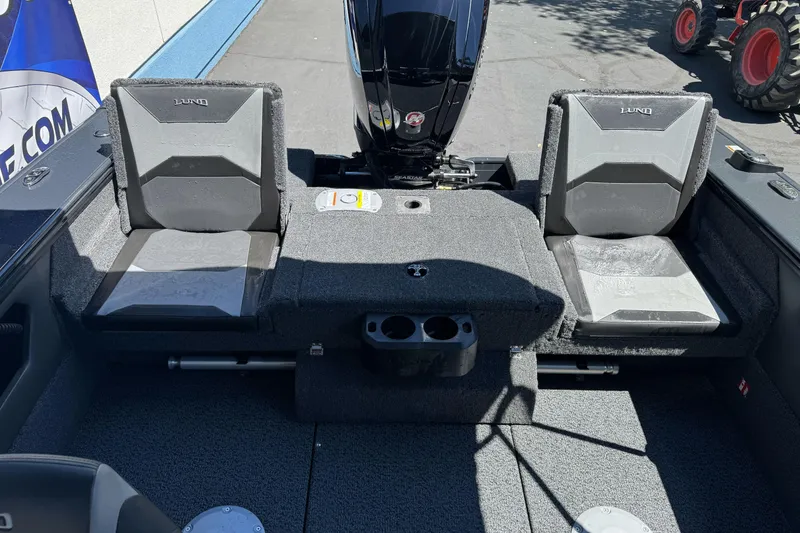 Slide: The Image of 2026 Lund 1775 Crossover XS boat interior with seating and motor, showcasing modern design. - 14