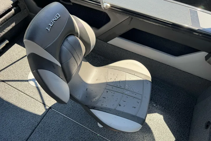 Slide: The Image of 2026 Lund 1775 Crossover XS boat seat with water droplets, showcasing modern design. - 12