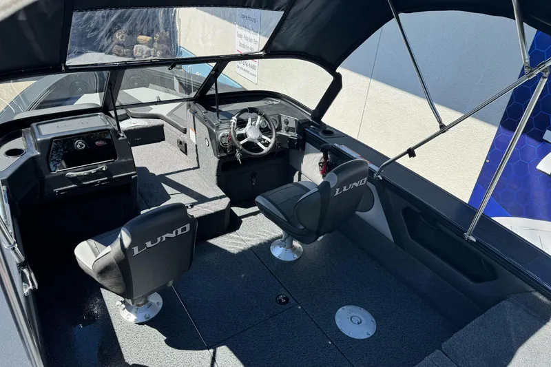 Slide: The Image of Interior of 2026 Lund 1775 Crossover XS boat with seating and steering console. - 18