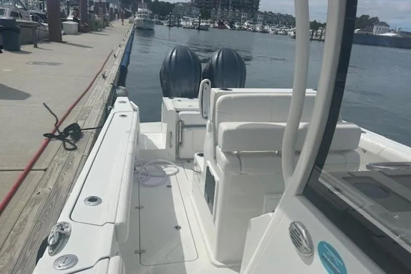 Slide: The Image of 2025 Parker 2900 Center Console boat docked at marina, featuring dual engines. - 10