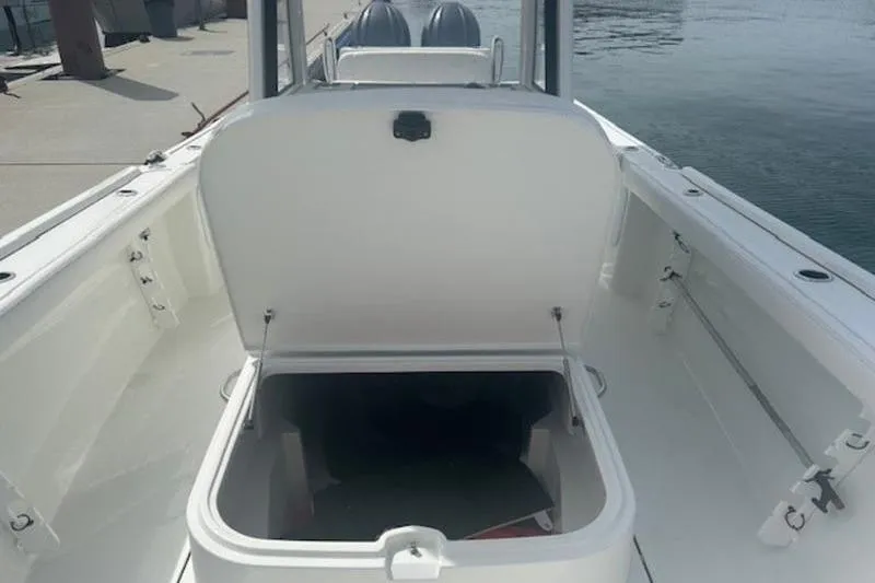 Slide: The Image of 2025 Parker 2900 Center Console boat with open storage compartment on deck. - 12