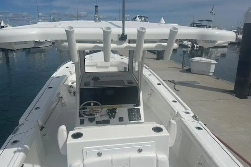 Slide: The Image of 2025 Parker 2900 Center Console boat docked at marina, featuring modern helm and rod holders. - 15