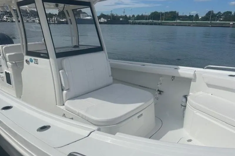 Slide: The Image of 2025 Parker 2900 Center Console boat with white seating, docked by the water. - 18