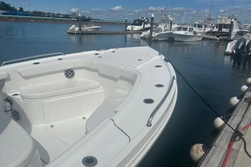 Slide: The Image of 2025 Parker 2900 Center Console boat docked in a marina under a clear sky. - 3