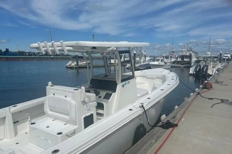 Slide: The Image of 2025 Parker 2900 Center Console boat docked at marina under blue sky. - 6