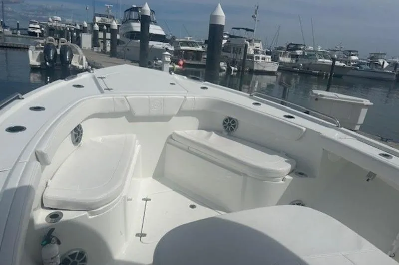 Slide: The Image of 2025 Parker 2900 Center Console boat docked at a marina, featuring spacious seating. - 9