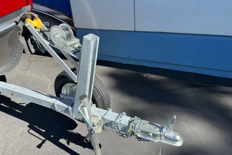 Slide: The Image of Trailer hitch and winch of 2026 Lund 1600 Fury SS boat on pavement. - 3