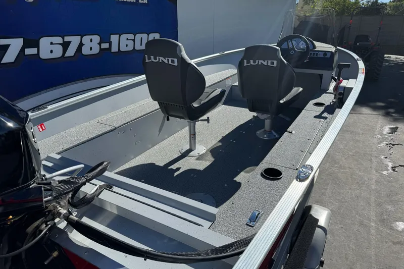 Slide: The Image of 2026 Lund 1600 Fury SS boat interior with two seats and steering console. - 4