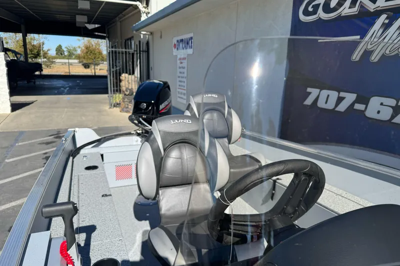 Slide: The Image of 2026 Lund 1600 Fury SS boat interior with steering wheel and seats. - 6