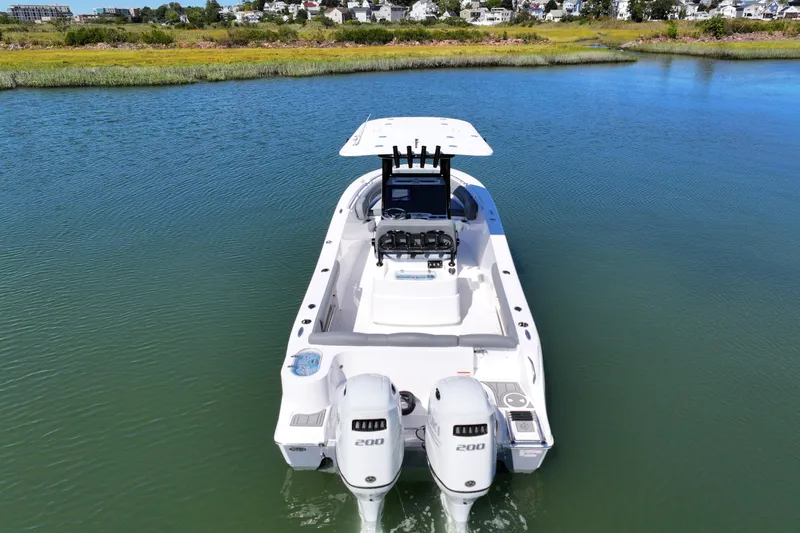 Slide: The Image of 2026 NauticStar 252 Legacy boat on calm water, featuring dual engines. - 20