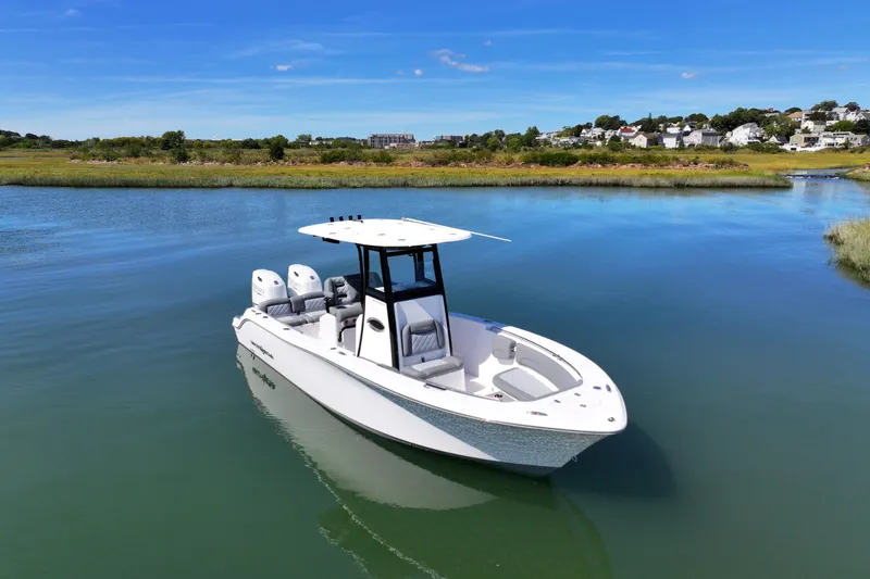 Slide: The Image of 2026 NauticStar 252 Legacy boat on calm water, scenic background. - 7