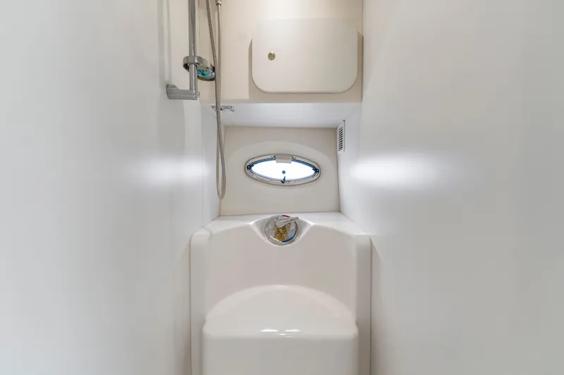 Slide: The Image of 2005 Silverton 34 Convertible yacht bathroom with shower and porthole window. - 12