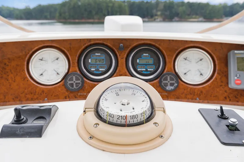 Slide: The Image of Dashboard of a 2005 Silverton 34 Convertible boat with compass and gauges. - 14