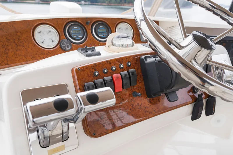 Slide: The Image of Control panel of a 2005 Silverton 34 Convertible boat with steering wheel and gauges. - 15