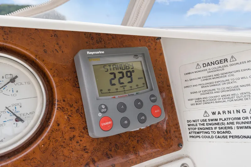 Slide: The Image of Control panel of 2005 Silverton 34 Convertible boat with Raymarine display and warning labels. - 17