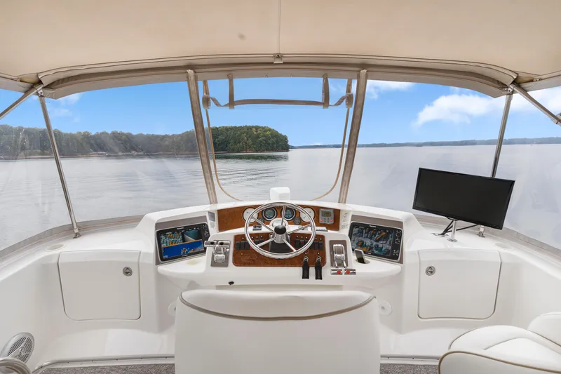 Slide: The Image of 2005 Silverton 34 Convertible yacht helm with panoramic lake view. - 22