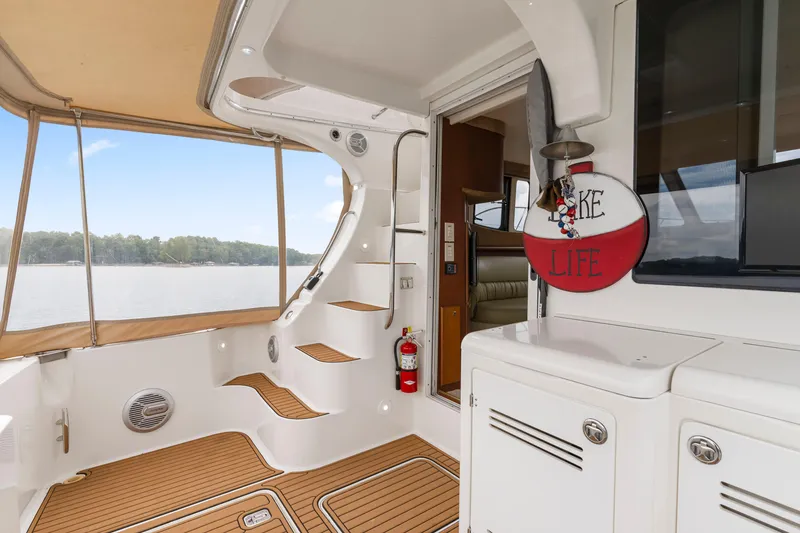 Slide: The Image of 2005 Silverton 34 Convertible yacht interior with wooden flooring and lake view. - 26