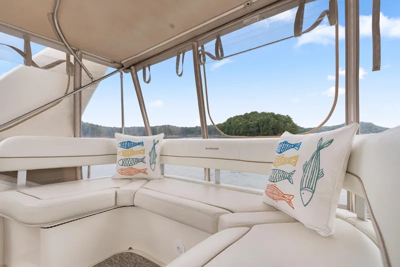 Slide: The Image of Interior of 2005 Silverton 34 Convertible yacht with fish-themed pillows and scenic view. - 27
