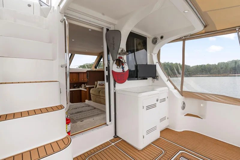 Slide: The Image of 2005 Silverton 34 Convertible yacht interior with stairs, seating, and lake view. - 29