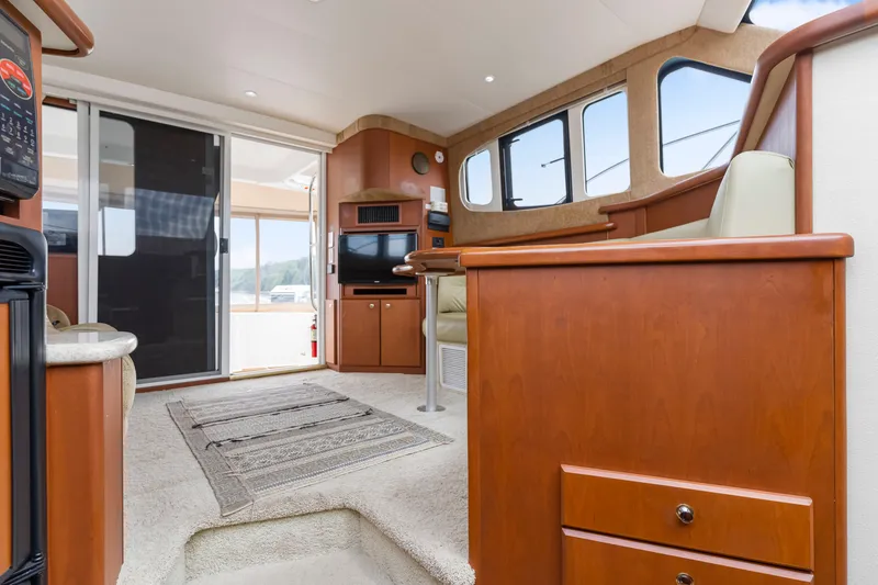 Slide: The Image of Interior of 2005 Silverton 34 Convertible yacht with modern furnishings and large windows. - 4