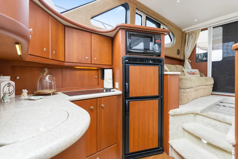 Slide: The Image of Interior of 2005 Silverton 34 Convertible yacht with kitchen and seating area. - 7