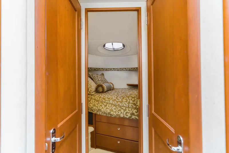 Slide: The Image of Interior cabin view of 2005 Silverton 34 Convertible yacht with elegant bedding. - 8