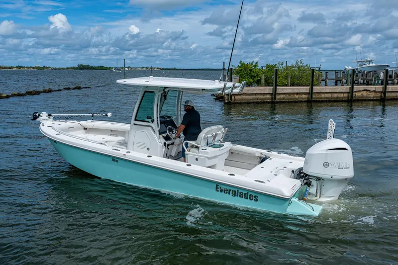 Slide: The Image of 2021 Everglades 253 Center Console boat on water, featuring Yamaha outboard motor. - 10