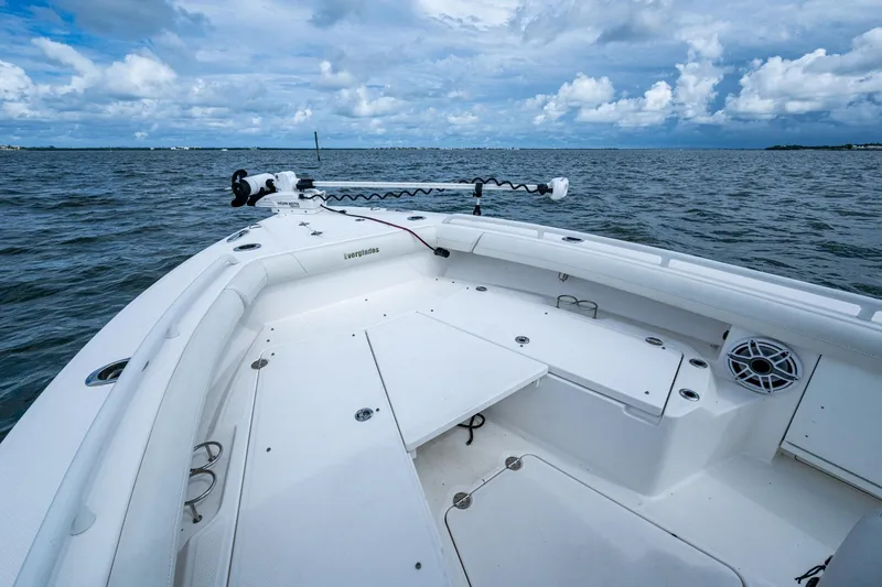Slide: The Image of 2021 Everglades 253 Center Console boat on open water under cloudy sky. - 14