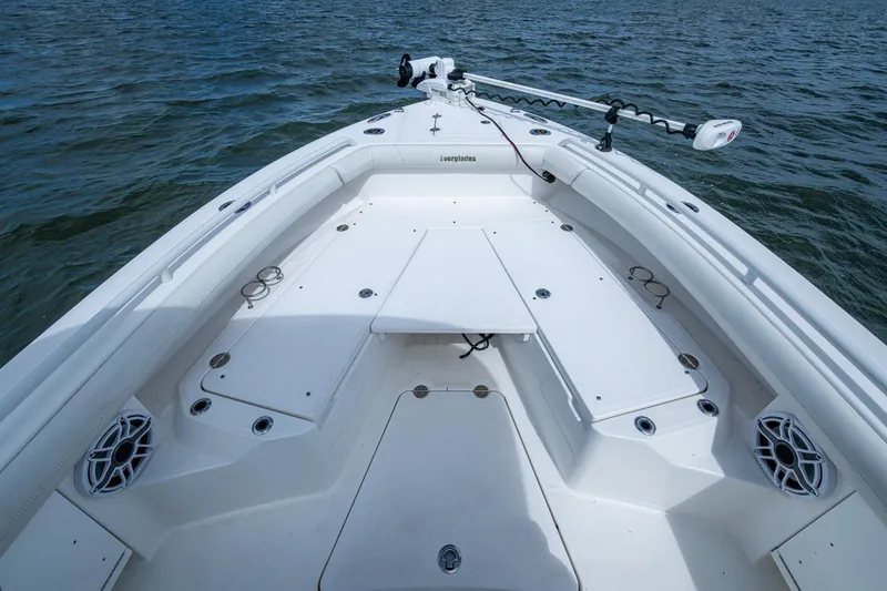 Slide: The Image of 2021 Everglades 253 Center Console boat on water, featuring spacious deck and modern design. - 16