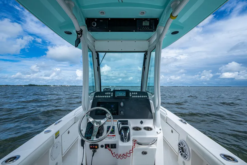 Slide: The Image of Everglades 253 Center Console 2021 boat on open water under blue sky. - 17
