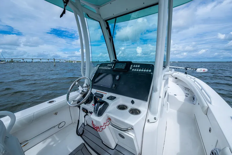 Slide: The Image of 2021 Everglades 253 Center Console boat interior with steering wheel and control panel. - 18