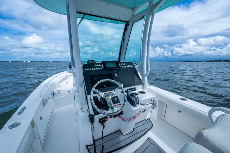 Slide: The Image of 2021 Everglades 253 Center Console boat on open water, featuring modern helm controls. - 19