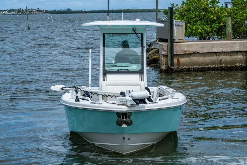 Slide: The Image of 2021 Everglades 253 Center Console boat on water, front view. - 2