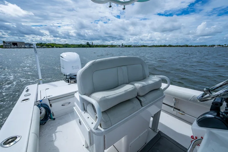 Slide: The Image of 2021 Everglades 253 Center Console boat on water, featuring comfortable seating and modern design. - 22