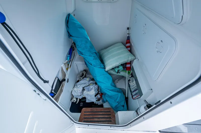 Slide: The Image of Interior storage of 2021 Everglades 253 Center Console boat with various items. - 28