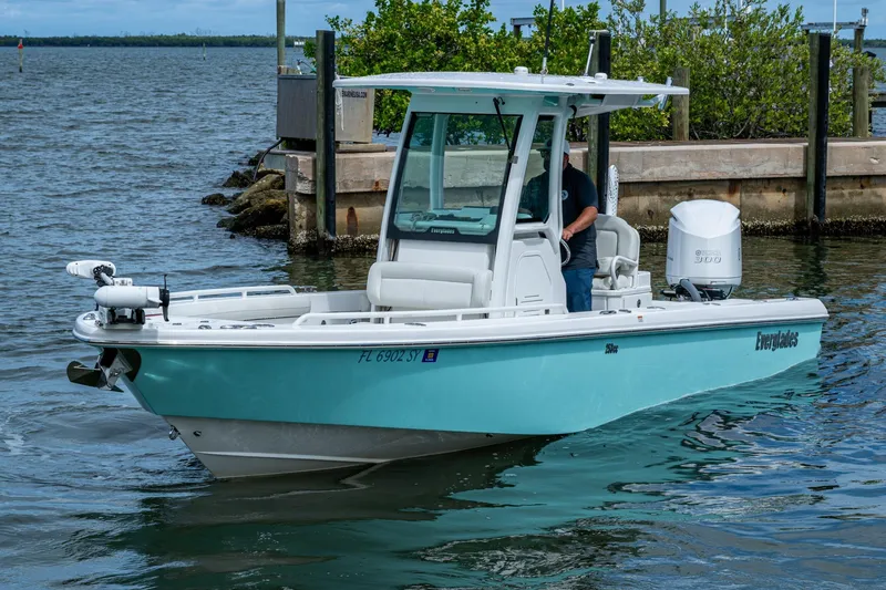 Slide: The Image of 2021 Everglades 253 Center Console boat on water near dock. - 3