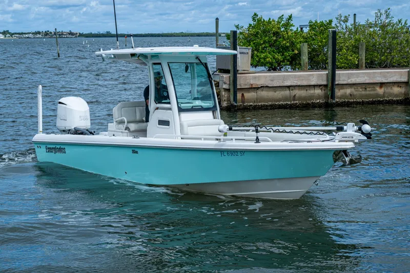 Slide: The Image of 2021 Everglades 253 Center Console boat cruising on a calm waterway. - 6