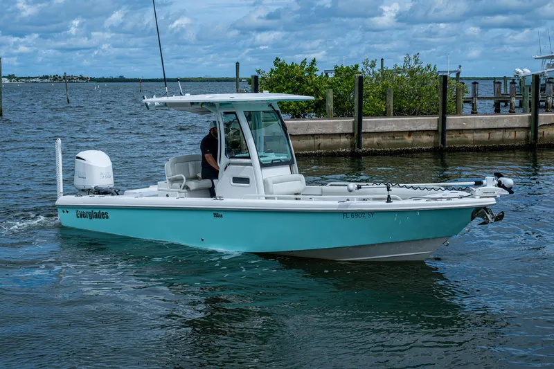 Slide: The Image of 2021 Everglades 253 Center Console boat on water, featuring sleek design and modern amenities. - 7