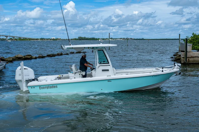 Slide: The Image of 2021 Everglades 253 Center Console boat cruising on a scenic waterway. - 8