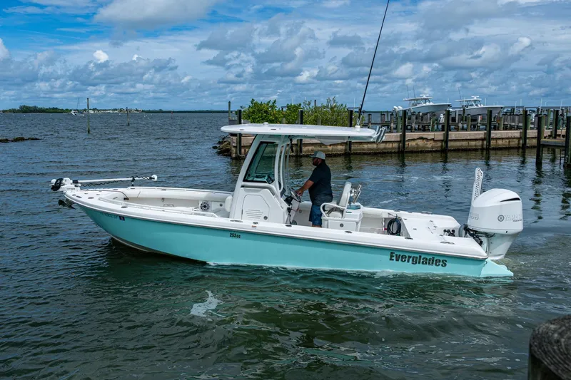 Slide: The Image of 2021 Everglades 253 Center Console boat cruising on a scenic waterway. - 9