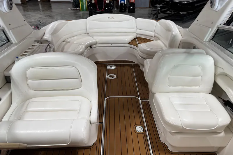 Slide: The Image of 2001 Sea Ray 280 Bow Rider interior with white leather seats and wooden flooring. - 6